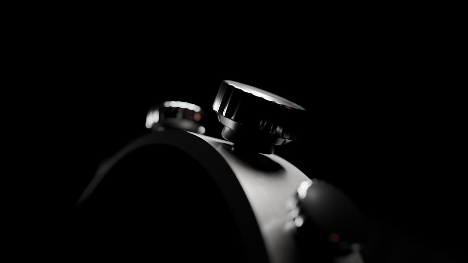 A watch lit against a dark background